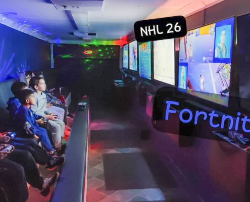 Kids playing Fortnite inside GameTrucks GT gaming trailer