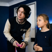 Game Coach helping a child during a video game party