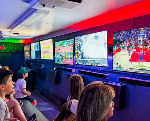 Kids playing video games inside a gaming truck in Toronto