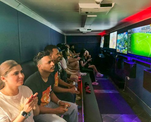 Adults playing video games at a corporate team building event