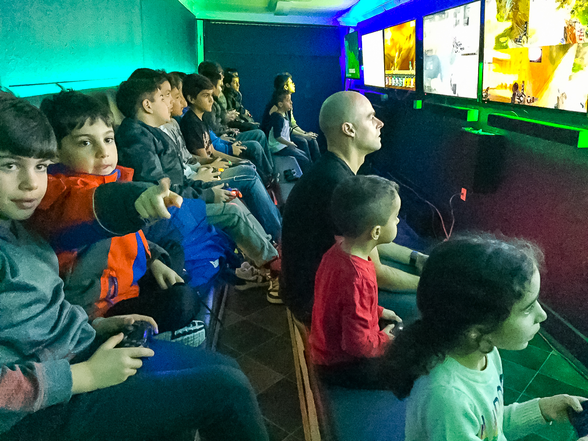 Multiplayer Video Game Party for Kids in Toronto Kids playing multiplayer video games on large gaming screens