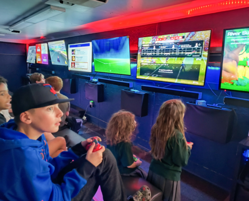 Kids playing multiplayer games at a video game party