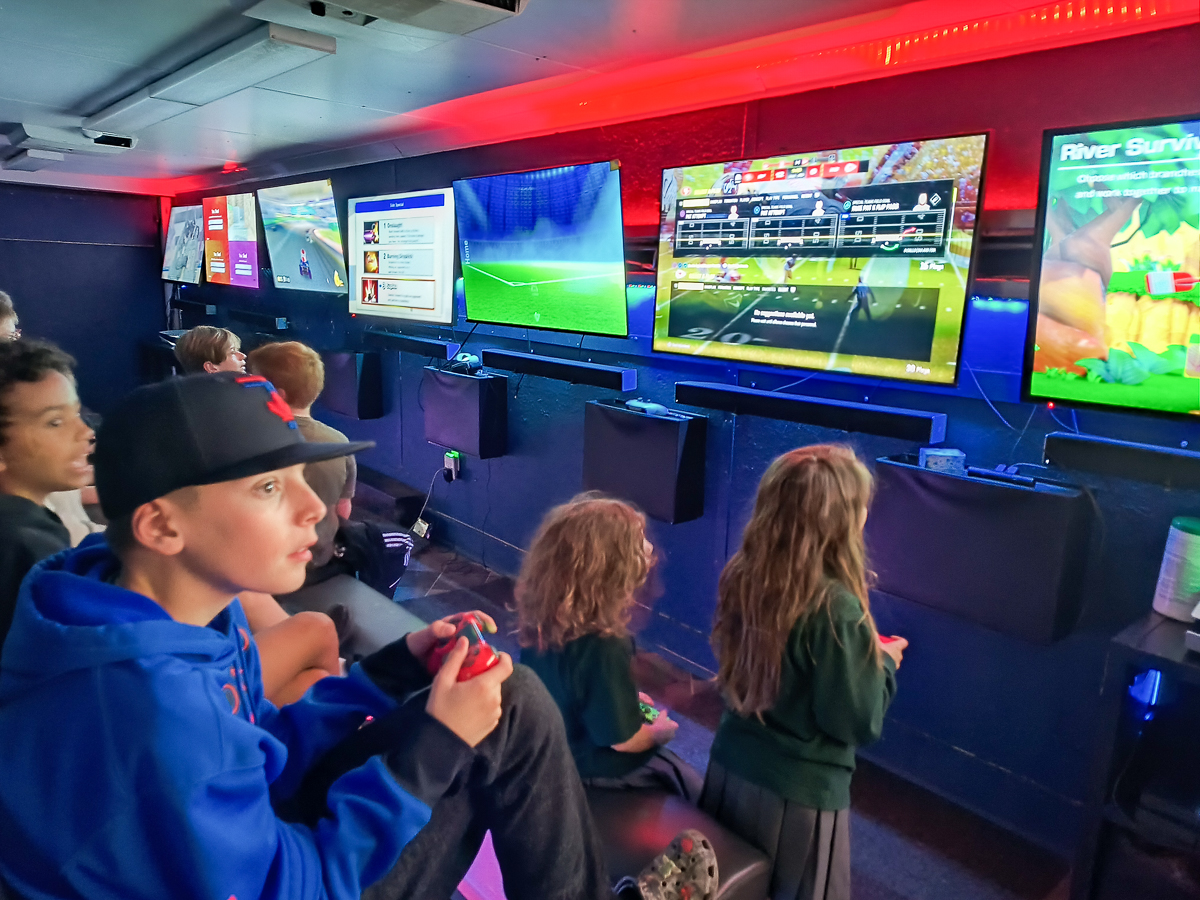 Kids playing multiplayer games at a video game party