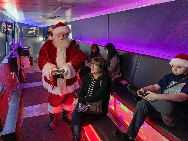 Santa playing video games with guests inside a mobile gaming truck Santa playing video games with guests inside a mobile gaming truck