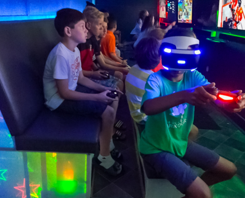 Boy playing virtual reality inside GameTrucks GT trailer