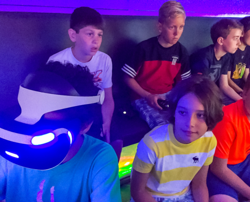 Kids playing virtual reality at a video game party